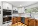 Bright kitchen featuring stainless steel appliances, two-tone cabinetry and hardwood floors at 11313 Haswell Dr, Parker, CO 80134