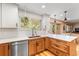 A modern kitchen features stainless steel appliances, stylish cabinetry and counters and hardwood floors at 11313 Haswell Dr, Parker, CO 80134