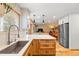 Bright kitchen with hardwood floors, sink, and stainless steel appliances at 11313 Haswell Dr, Parker, CO 80134