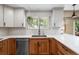 A well-lit kitchen features stainless steel appliances, stylish cabinetry and counters and hardwood floors at 11313 Haswell Dr, Parker, CO 80134
