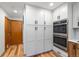 Bright kitchen with built in ovens, white cabinets and hardwood floors at 11313 Haswell Dr, Parker, CO 80134