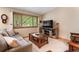Cozy living room with comfortable seating, a wooden coffee table, and a bright window view at 11313 Haswell Dr, Parker, CO 80134