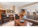 Inviting living room with a fireplace, comfortable seating, and an open staircase at 11313 Haswell Dr, Parker, CO 80134
