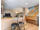 Open living space with a breakfast nook, a piano, and views into the living room and staircase at 11313 Haswell Dr, Parker, CO 80134