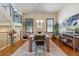 Bright dining room with hardwood floors, large windows and a modern table at 2800 S Dexter Way, Denver, CO 80222