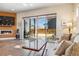 Living area with fireplace, hardwood floors and sliding glass doors to patio at 2800 S Dexter Way, Denver, CO 80222