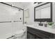 Modern basement bathroom, featuring a white subway tile shower and dark vanity at 1835 S Lincoln St, Denver, CO 80210