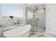 Luxurious bathroom with a soaking tub, a seamless glass shower, and marble accents at 1835 S Lincoln St, Denver, CO 80210