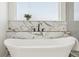 Stylish bathroom featuring a modern soaking tub and elegant marble tile surround at 1835 S Lincoln St, Denver, CO 80210