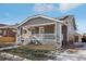 Charming craftsman bungalow with gray siding, front porch and solar panels at 1835 S Lincoln St, Denver, CO 80210