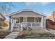 Charming craftsman style home with gray siding, white trim, and a welcoming front porch at 1835 S Lincoln St, Denver, CO 80210