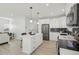 Modern kitchen featuring a central island, stainless steel appliances, and sleek white cabinetry at 1835 S Lincoln St, Denver, CO 80210