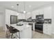 Modern kitchen featuring white cabinets, quartz countertops, and stainless steel appliances at 1835 S Lincoln St, Denver, CO 80210