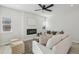 Open and airy living room with a cozy seating area and fireplace at 1835 S Lincoln St, Denver, CO 80210
