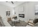 Bright living room features a modern fireplace, plush seating, and natural light from multiple windows at 1835 S Lincoln St, Denver, CO 80210
