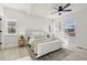 Bright main bedroom with a ceiling fan, multiple windows, and neutral decor at 1835 S Lincoln St, Denver, CO 80210