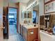Cozy bathroom featuring a single sink vanity and a large mirror with vanity lights at 10035 E Mexico Ave, Aurora, CO 80247