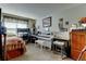 Bright bedroom featuring a music studio with a white piano and a beige carpet at 10035 E Mexico Ave, Aurora, CO 80247
