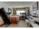 Bedroom featuring natural light, carpeted floors, and space for a home music studio at 10035 E Mexico Ave, Aurora, CO 80247