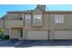Exterior of townhome featuring a two-car garage, door access, and neutral siding at 10035 E Mexico Ave, Aurora, CO 80247