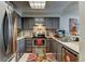 Efficient kitchen featuring stainless steel appliances, modern cabinets, and bright lighting at 10035 E Mexico Ave, Aurora, CO 80247
