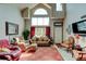 Spacious living room with high ceilings, natural light, and cozy seating arrangements at 10035 E Mexico Ave, Aurora, CO 80247