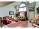 Bright living room with soaring ceilings, large windows, and comfortable seating area at 10035 E Mexico Ave, Aurora, CO 80247