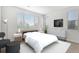 This bedroom is bright, and spacious with a large window and white walls at 301 Inverness S Way # 202, Englewood, CO 80112