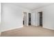 Neutral bedroom with three doors for closets and bathroom access at 301 Inverness S Way # 202, Englewood, CO 80112