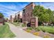 Brick apartment building with manicured landscaping and clear community signage, setting a welcoming tone at 301 Inverness S Way # 202, Englewood, CO 80112