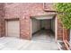 Attached two-car garage with brick exterior and access to the interior at 301 Inverness S Way # 202, Englewood, CO 80112