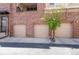 Three-car garage with brick exterior, ideal for ample parking and storage at 301 Inverness S Way # 202, Englewood, CO 80112