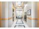 Hallway featuring elevator access, decorative mailboxes, and neutral color palette, showcasing convenience and style at 301 Inverness S Way # 202, Englewood, CO 80112