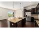 Kitchen with granite island, stainless steel appliances, and balcony access, creating a modern and functional space at 301 Inverness S Way # 202, Englewood, CO 80112