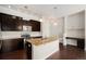 Kitchen with granite countertops, stainless steel appliances, and dark wood cabinetry, blending style and functionality at 301 Inverness S Way # 202, Englewood, CO 80112