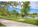 Community park with picnic tables, BBQ area, walking paths, and a serene pond at 301 Inverness S Way # 202, Englewood, CO 80112