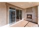 Patio with a gas fireplace and sliding door access to the inside at 301 Inverness S Way # 202, Englewood, CO 80112