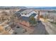 Aerial view of a landscaped yard and a brick two-story home with a patio and a well-maintained garden at 767 Ellis St, Golden, CO 80401