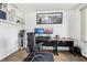Bright home office featuring built-in shelves, modern desk setup, and wood flooring at 767 Ellis St, Golden, CO 80401