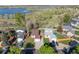 An aerial view showing homes near a lake surrounded by green trees and lush grass at 17593 E Temple Dr, Aurora, CO 80015