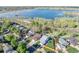 Aerial view of homes near a lake shows green trees and well-maintained lawns at 17593 E Temple Dr, Aurora, CO 80015