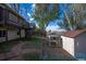 The backyard features an elevated deck and a pathway with red bricks leading to the chicken coop and storage shed at 17593 E Temple Dr, Aurora, CO 80015