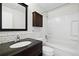 Beautiful bathroom features a dark vanity, modern fixtures, and subway tile in the bathtub and shower surround at 17593 E Temple Dr, Aurora, CO 80015