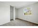 Carpeted bedroom with large closet, bright natural light and backyard views from the window at 17593 E Temple Dr, Aurora, CO 80015
