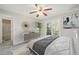 This staged bedroom features gray carpet, a ceiling fan, and glass doors to a balcony at 17593 E Temple Dr, Aurora, CO 80015
