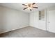 A bedroom offers carpeted floors, a ceiling fan, and a spacious closet with shelving at 17593 E Temple Dr, Aurora, CO 80015