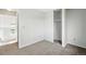 A carpeted bedroom features a closet, neutral walls, and a hallway visible through the doorway at 17593 E Temple Dr, Aurora, CO 80015