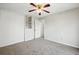 A bright bedroom with light gray carpet features a large closet and built-in shelving at 17593 E Temple Dr, Aurora, CO 80015