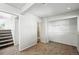 This carpeted bedroom has a walk-in closet and doorway to stairs that lead to the home's main floor at 17593 E Temple Dr, Aurora, CO 80015