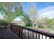 A view from the wooden deck highlighting the beautiful foliage in the backyard at 17593 E Temple Dr, Aurora, CO 80015